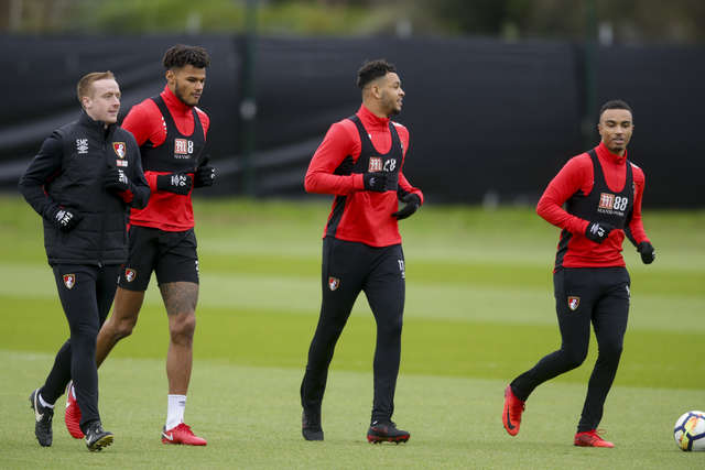 Tyrone Mings, Joshua King and Junior Stanislas walk together in training.