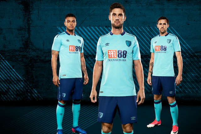 Joshua King, Andrew Surman and Charlie Daniels pose in the new neon blue away kit for the 2017/18 season.